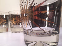 Load image into Gallery viewer, Fred Press - Signed Mid-Century Celestial/Atomic Burst 22-Karat Gold &amp; Black Whiskey Glasses (Set of 4)
